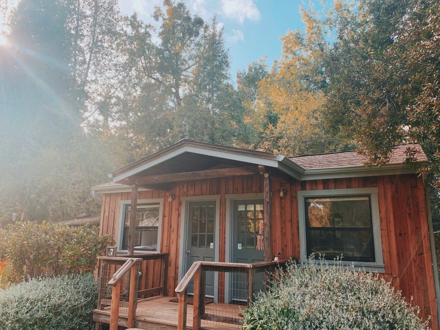 Interior of a wilderness cabin with queen bed and warm wood finishes